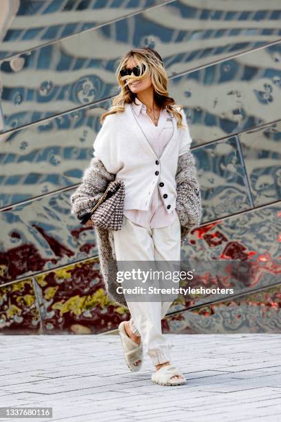 Influencer Gitta Banko wearing a beige blouse by Brunello Cucinelli, a beige cardigan by Brunello Cucinelli, a beige coat with sequin detail by...