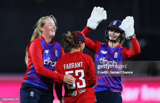Sophie Ecclestone, Tash Farrant and Amy Jones of England celebrate dismissing Maddy Green of New Zealand during the International T20 match between...
