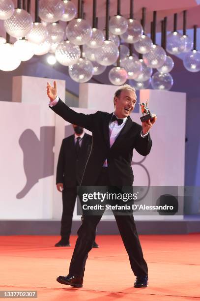 Roberto Benigni poses with the Golden Lion for lifetime achievement during the opening ceremony during the 78th Venice International Film Festival on...
