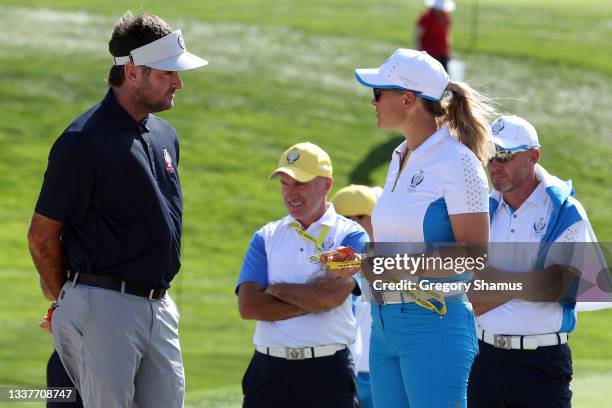 Bubba Watson talks with Team Europe Vice Captain Suzann Pettersen during a practice round ahead of the start of The Solheim Cup at Inverness Club on...