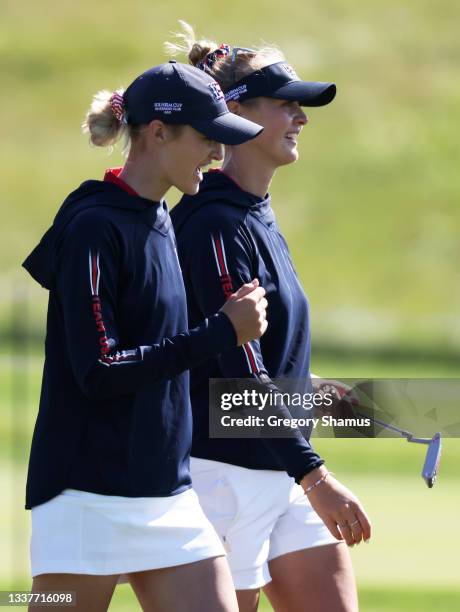 Nelly Korda and Jessica Korda of Team United States walk together during a practice round ahead of the start of The Solheim Cup at Inverness Club on...