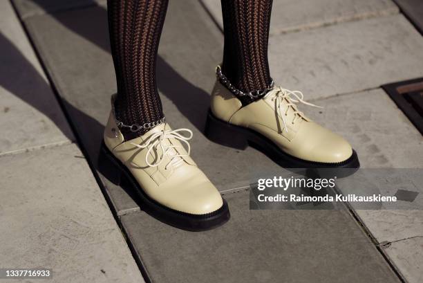 Emma Fridsell wearing black Swedish Stockings , knitted shorts and black knitted sweater, light beige shoes and brown bag during Stockholm fashion...