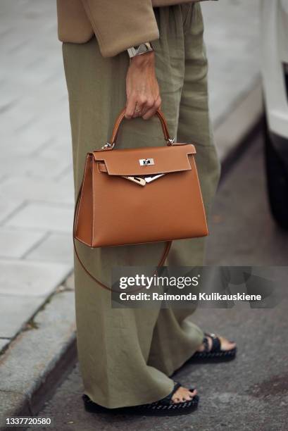 Emilia de Poret wearing beige wide pants, white shirt, and beige Prada jacket and brown Hermes bag during Stockholm fashion week Spring/Summer 2022...