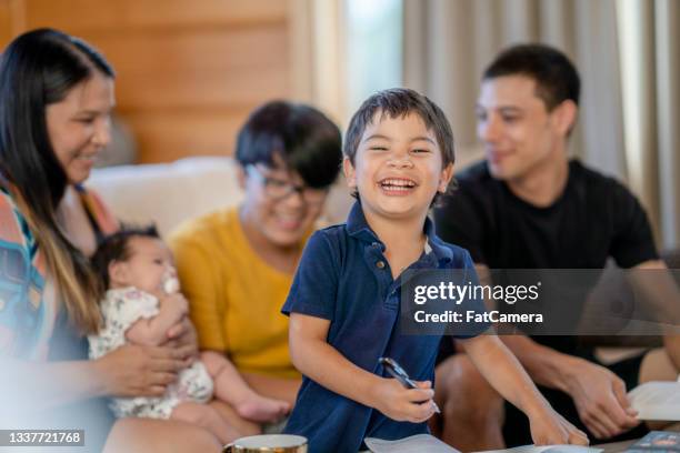 lächelnder vierjähriger junge, der zeit mit seiner familie zu hause verbringt - canadian culture stock-fotos und bilder