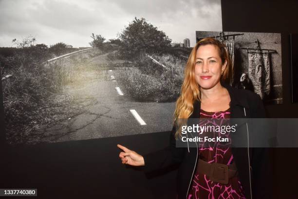 Myriam Charleins poses with her favorite work of Pierre Faure during “Odyssees” by Aglae Bory and collective exhibition hosted by Caritas at Agnes...