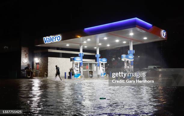 Person walks through floodwaters on Newark Street caused by the remnants of Hurricane Ida drenching the New York City and New Jersey area on...