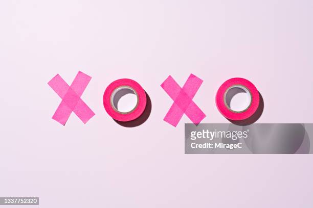 xoxo word made of pink adhesive tape - love is /// stock-fotos und bilder
