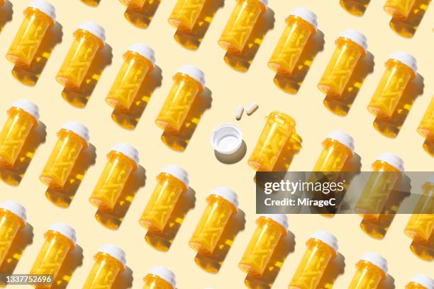 opened prescription medicine bottle among many other sealed bottles - dose 個照片及圖片檔