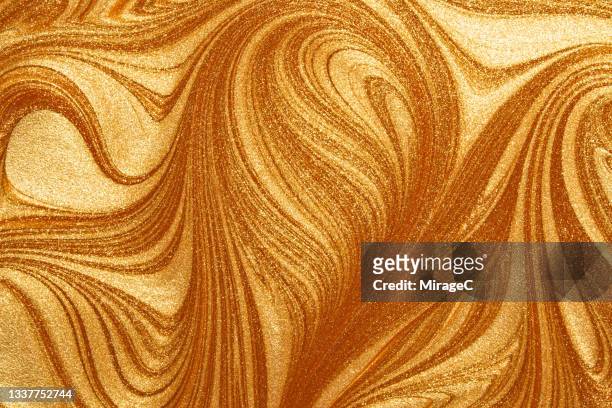 flowing glitter gold paint rippled pattern - bling bling ストックフォトと画像