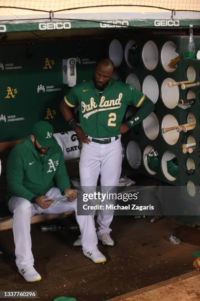 Mitch Moreland and Starling Marte of the Oakland Athletics in the dugout during the game against the San Francisco 49ers at RingCentral Coliseum on...