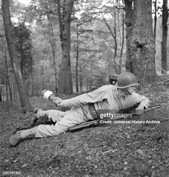 Sergeant George Camblair learning how to use a "Molotov Cocktail", Fort Belvoir, Virginia, USA, Jack Delano, U.S. Office of War Information,...