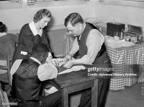 Miss Teal, Nurse, and Doctor W.R. Stanley giving treatment in Venereal Disease Clinic. Enterprise, Alabama, USA, Marion Post Wolcott, U.S. Farm...