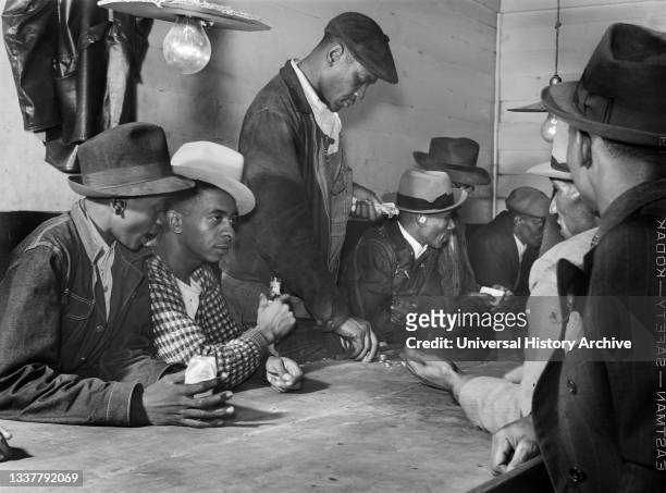 Men spending their money in Gambling and Juke Joint, Saturday night, outside Clarksdale, Mississippi, USA, Marion Post Wolcott, U.S. Farm Security...