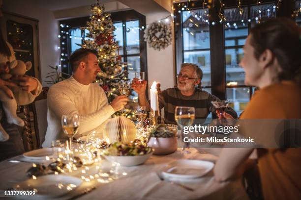 family christmas dinner - multi generation family christmas stock pictures, royalty-free photos & images