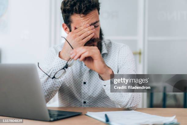 tired businessman - rubbing eyes stock pictures, royalty-free photos & images
