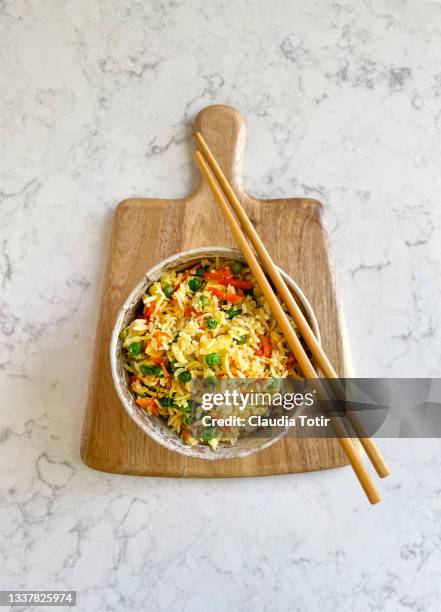 bowl of fried rice with vegetables on white background - fried rice stock-fotos und bilder