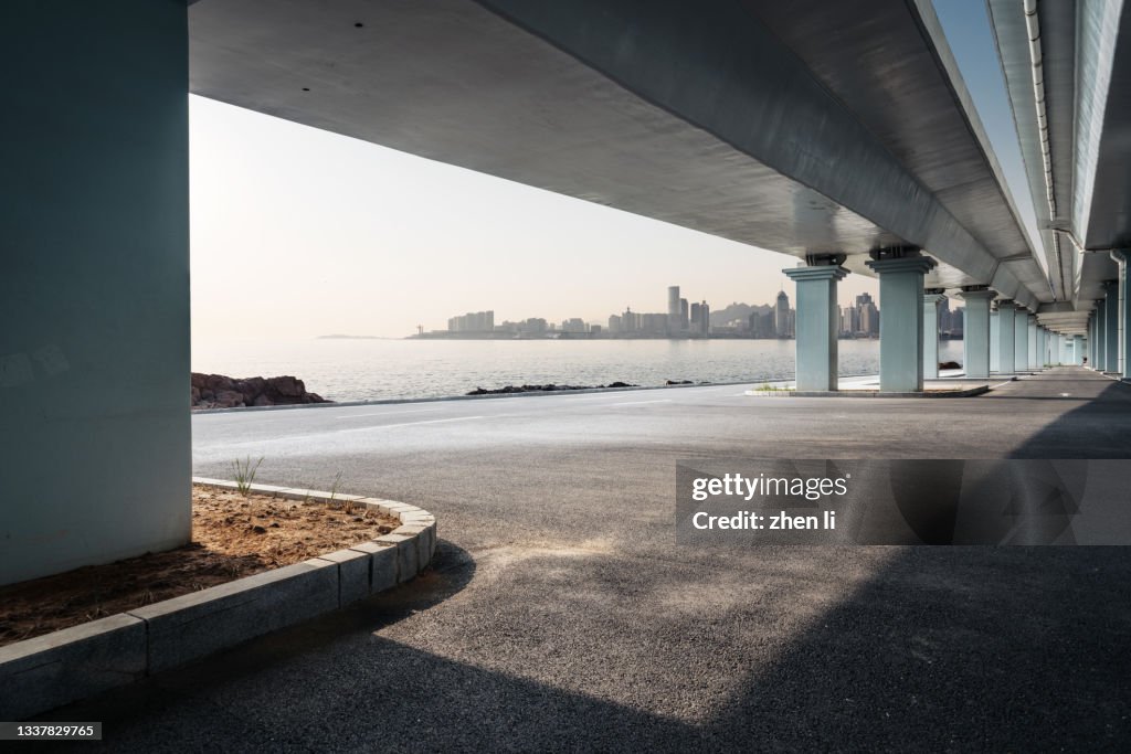 Asphalt road under the coastal viaduct