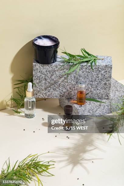 industry of marijuana and products with cbd. bottles with cannabis oil and cosmetic products - cbd products stock pictures, royalty-free photos & images