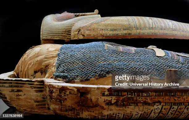 An Anthropoid Coffin containing the mummy of the priest of MONTU , inscribed in hieroglyphics. Painted Plaster, Linen and wood. Deir El Bahari,...