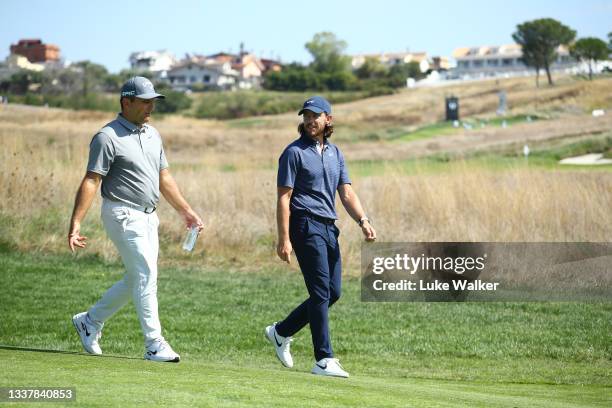 Francesco Molinari of Italy and Tommy Fleetwood of England walk together on the seventh hole during Day One of The Italian Open at Marco Simone Golf...