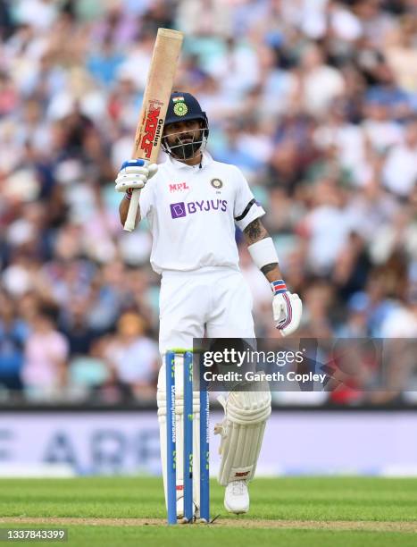 India captain Virat Kohli salutes the dressing room after reaching his half century during day one of the Fourth LV= Insurance Test Match between...