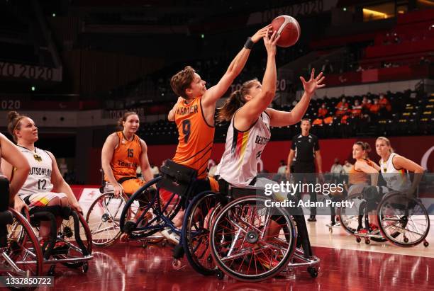 Bo Kramer of Team Netherlands blocks a shot from of Katharina Lang of Team Germany during the women's wheelchair basketball semi final match between...