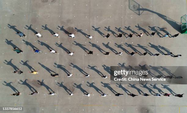 Students practice martial arts during PE class at a middle school on September 2, 2021 in Huanghua County, Cangzhou City, Hebei Province of China.