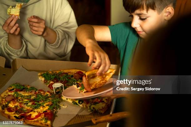 eat a big and delicious pizza together, at home - ordering stock pictures, royalty-free photos & images