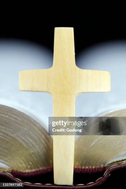 Open bible with christian cross. Faith and sprituality. France.