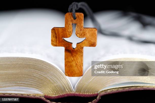 Open bible with christian cross. Faith and sprituality. France.