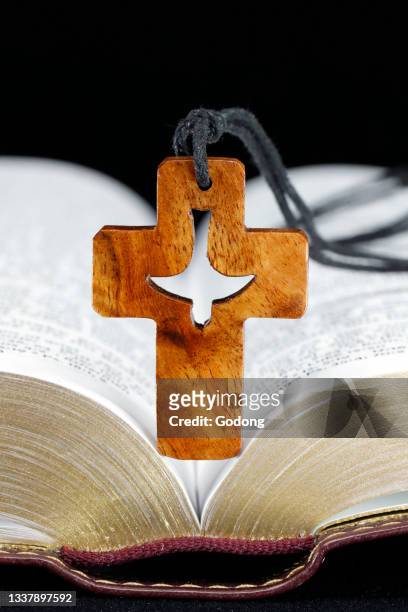 Open bible with christian cross. Faith and sprituality. France.