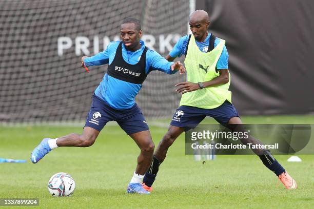 Shaun Wright-Phillips and Sir Mo Farah in action during Soccer Aid For Unicef 2021 training at Mottram Hall on September 02, 2021 in Wilmslow,...