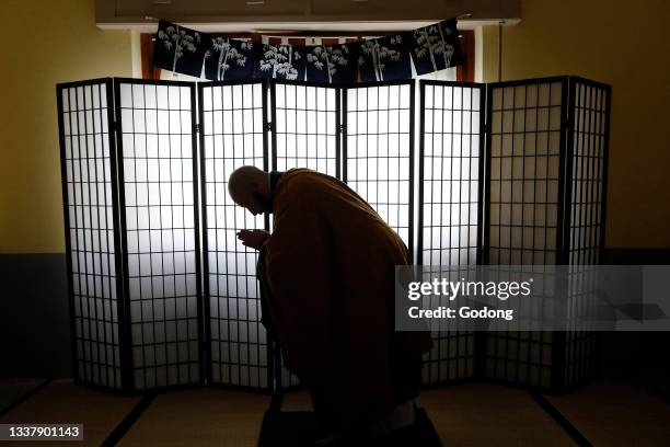 Zen buddhist master prosternating in his dojo in Marrubiu, Sardinia, Italy.