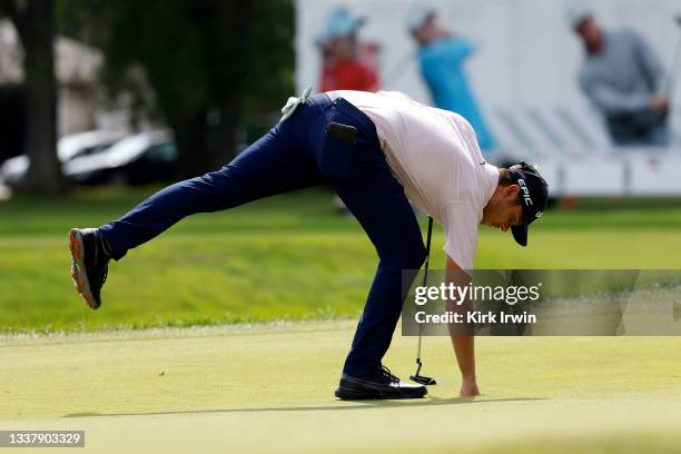 Adam Svensson of Canada picks up his ball during the final round of the Nationwide Children’s Hospital Championship at The Ohio State University Golf...