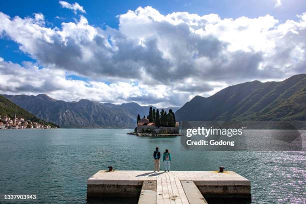 Visitors looking at St George island, Perast, Montenegro.