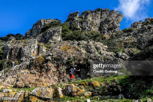 Trekker on Arcuentu mountain, Sardinia, Italy.