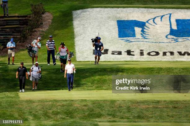 Roberto Diaz of Mexico and Adam Svensson of Canada walk up the course during the final round of the Nationwide Children’s Hospital Championship at...