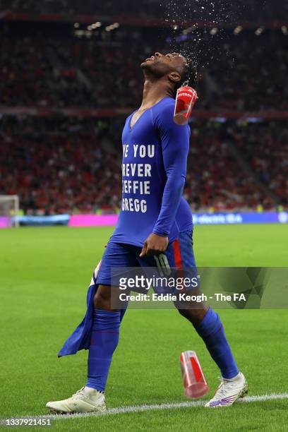 Raheem Sterling of England celebrates after scoring their team's first goal wearing a t-shirt that reads "Love You Forever Steffie Gregg" during the...
