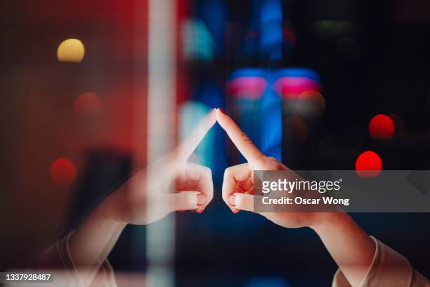 female hand using touch screen in the dark at night - touching stock pictures, royalty-free photos & images