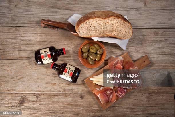 Sardinian raw ham. Sardinian raw pork sausage. Sardinian pecorino cheese plate. Olives. Whole grain bread. Unfiltered Ichnusa beer. Sardinia. Italy....