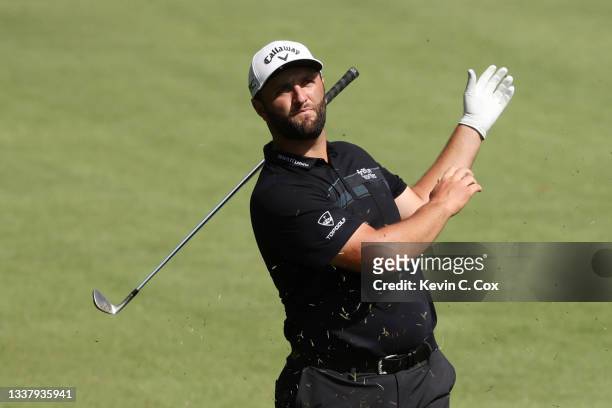 Jon Rahm of Spain drops his club as he plays a shot on the tenth hole during the first round of the TOUR Championship at East Lake Golf Club on...