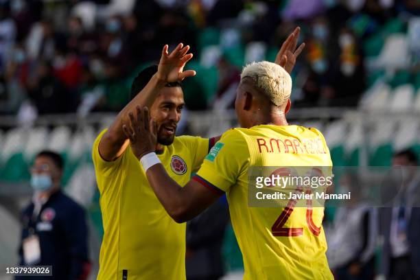 Roger Martinez of Colombia celebrates with teammates after scoring the first goal of his team during a match between Bolivia and Colombia as part of...