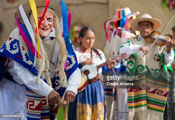 Mexican musicians and man wearing Danzante mask for the Danza de los Viejitos, traditional folk dance in the town P‡tzcuaro, Michoaca_n, Mexico.