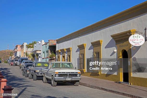 Street with restaurants and bars in the coastal village Todos Santos on the peninsula of Baja California Sur, Mexico.