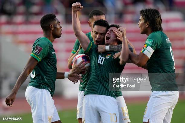 Fernando Saucedo of Bolivia celebrates with teammates after scoring the first goal of his team during a match between Bolivia and Colombia as part of...