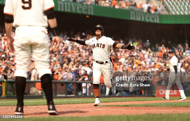 Thairo Estrada of the San Francisco Giants reacts as he rounds the bases after he hit a three-run home run in the eighth inning against the Milwaukee...