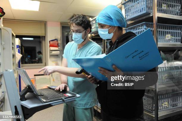 Medical intensive care unit at Jacques Cartier Hospital in Massy. Nurse and nursing assistant replenish stocks in the department pharmacy used for...