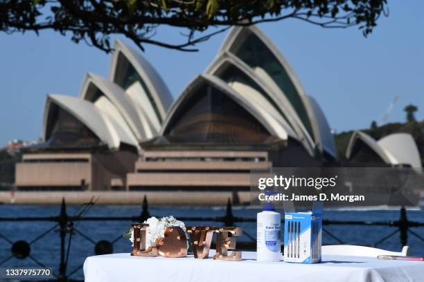 Hand sanitiser is placed next to a LOVE sign on a table at the wedding of Daniel and Ella Kim held at Olympic Park in the suburb of Milsons Point on...