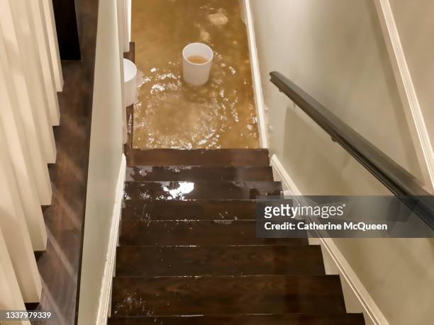 flood water flowing down staircase into house basement - basement stock pictures, royalty-free photos & images