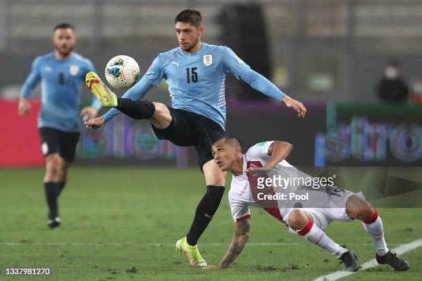 Federico Valverde of Uruguay competes for the ball with Yoshimar Yotún of Perú during a match between Peru and Uruguay as part of South American...